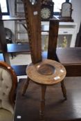 A reproduction spinning chair, of traditional design, the slender tapering back with cut-out lobed