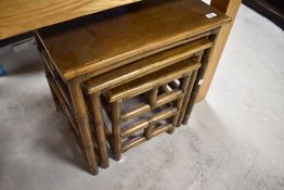 A nest of three modern bamboo and hardwood occasional tables, the bamboo supports and stretcher