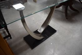A modern stylised glass and chrome console table, approx. 122 x 46cm