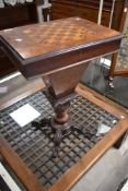 A Victorian walnut pedestal work/sewing table, the rectangular hinged top with geometric chequer