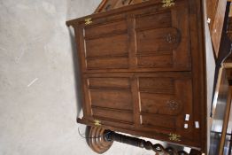 A traditional oak corner wall cupboard, having rosette carving decoration, width approx 96cm, height