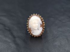 A 9ct gold large shell cameo ring, the prominent cameo possibly depicting Hera in an ornate claw