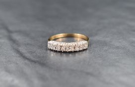 A 9ct gold diamond half eternity ring, the two rows of eighteen diamond chips in illusion