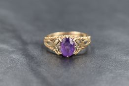 A 9ct gold amethyst ring, the oval cut amethyst measuring approximately 0.80ct, having pierced