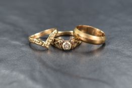 Three 9ct gold rings including wedding band, wishbone and diamond chip solitaire, approx 8.2g