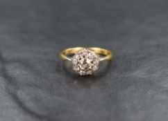 A diamond cushion cluster ring, approx 0.7ct total in a claw set mount to knife blade shoulders on a