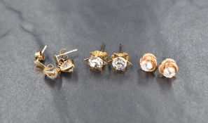 Three pairs of 9ct gold and yellow metal cubic zirconia earrings, comprising a pair of 9ct heart