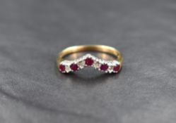 A 9ct gold diamond and ruby wishbone ring, the five round cut rubies measuring approximately 0.07ct,