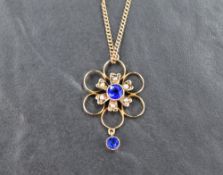 A yellow metal Edwardian seed pearl and paste set pendant marked 9ct, on a yellow metal curb link
