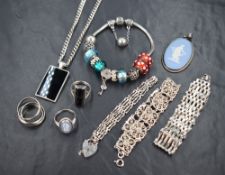 An assortment of silver and white metal jewellery, including a Pandora bracelet with Pandora and