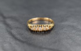An 18ct gold five stone diamond ring, the graduated diamonds in an open gallery setting, ring size