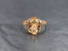 A 9ct gold citrine solitaire ring, the oval cut citrine measuring approximately 12.5mm x 9mm x 6.5mm