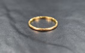 A 22ct gold thin band, having engraved indents, ring size M-N, 1.5g