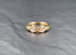 A 9ct gold diamond band, the infinity knot motif band set with four round cut diamonds flanking