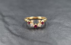 An 18ct gold ruby and diamond wishbone ring, the alternating rubies and diamonds measuring from