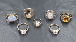 Seven silver and white metal rings of various forms, including cubic zironia, mother of pearl,