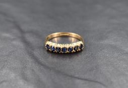 A 9ct gold sapphire half eternity band, the seven round cut sapphire in claw settings, ring size P-