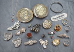 An assortment of silver and other jewellery, including silver brooches, a belt buckle having