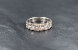 A 14ct white gold diamond band, the central eleven princess cut diamonds measuring approximately 1.