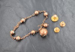 A rose metal and turquoise bracelet marked 9ct, the chain bracelet interspersed with metal beads set
