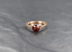 A 9ct gold garnet solitaire ring, the round cut garnet in an eight claw setting, ring size N, 1.8g