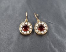 A pair of 9ct gold loop drop earrings having garnet and seed pearl set circular discs, approx 4.2g