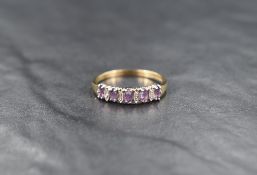A 9ct gold amethyst and diamond band, the five marquise cut amethysts interspersed with diamond