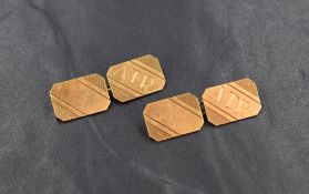 A pair of 18ct gold cufflinks, the emerald cut panels having 'A.T.R' and line work engraving with