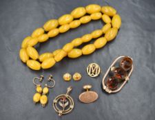 An Edwardian yellow metal pendant stamped 9ct having garnet and seed pearl floral decoration, no