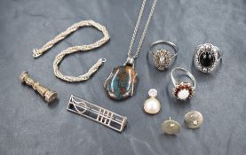 An assortment of silver jewellery, including an opal and garnet ring, a Rennie Mackintosh inspired