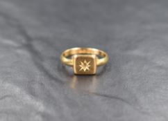 An 18ct gold signet style ring, the square panel missing the central gemstone within a star setting,