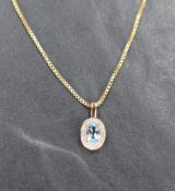 A 9ct gold diamond and aquamarine necklace, the central aquamarine measuring approximately 0.40ct in