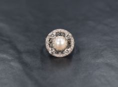 An 18ct white gold pearl and diamond ring having a central cultured pearl within a halo border set