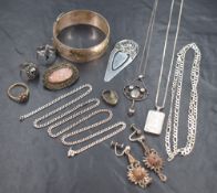 An assortment of silver and white metal jewellery, including a silver bangle with scroll