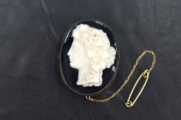 A 9ct gold banded agate cameo brooch, the banded agate having a cameo attached to the surface, in