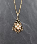 A 9ct gold pendant having three small opal cabochons in an open decorative mount on a 9ct gold