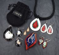An assortment of necklace and drop earring sets, comprising an ammonite set, a red glass petal motif