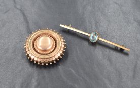 A yellow metal sunburst motif mourning brooch, having a clear back and a lock of hair, along with