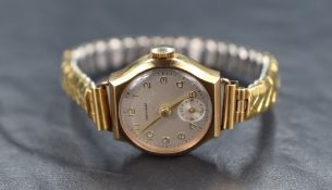 A 9ct gold Koh-I-Noor wristwatch, the white dial having Arabic numerals and subsidiary dial, on a
