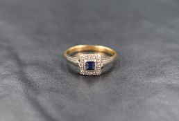 An 18ct gold Art Deco sapphire and diamond ring, the central square step cut sapphire with an