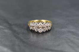 An 18ct gold diamond ring, the two rows of seven graduated round cut diamonds measuring from