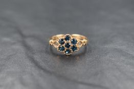 A 9ct gold blue topaz cluster ring, the seven round cut topaz in a floral motif cluster, having