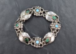 An early 20th Century silver bracelet by Georg Jensen having eight moulded links set with