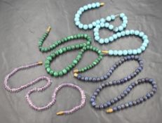 Four gemstone bead necklaces, comprising malachite, turquoise, amethyst and possibly lapis lazuli,
