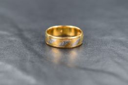 A 22ct gold and platinum band, the 22ct gold band having alternating decorative platinum panels with