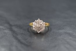 An 18ct gold diamond chip triple cluster ring in a claw set basket mount, ring size N/M and