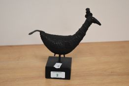 A 19th Century cast metal Indian peahen study, raised on a wooden base of square section and