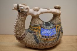 A vintage middle eastern drinking jug in the form of a camel, having stamp to base and measuring