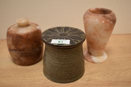 A mid-20th Century lidded stoneware preserve pot, measuring 9cm high, and two soapstone vessels -