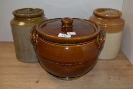 Two vintage stoneware jars sold alongside an earthenware style casserole/oven dish.